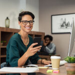 stylish-business-woman-using-smartphone-7ASWUC9.jpg
